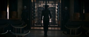 Movie still from “Star Trek: Nemesis” (2002), directed by Stuart Baird – A person walking in front of an open door; Wide shot, Over the shoulder angle