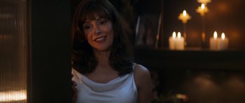 Movie still from “Star Trek: Nemesis” (2002), directed by Stuart Baird – A woman in a white dress smiling for the camera; Close Up shot, Over the shoulder angle