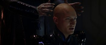 Movie still from “Star Trek: Nemesis” (2002), directed by Stuart Baird – A bald man is getting his head shaved; Close Up shot, Over the shoulder angle
