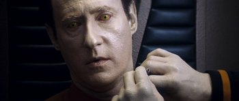 Movie still from “Star Trek: Nemesis” (2002), directed by Stuart Baird – A person putting on a ring; Close Up shot, Overhead angle