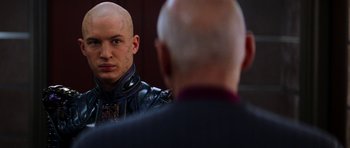 Movie still from “Star Trek: Nemesis” (2002), directed by Stuart Baird – A man with a shaved head looking at himself in the mirror; Close Up shot, Over the shoulder angle