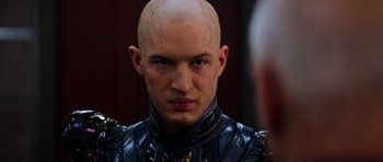 Movie still from “Star Trek: Nemesis” (2002), directed by Stuart Baird – A man with a shaved head and a tattoo on his face; Close Up shot, Over the shoulder angle