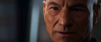 Movie still from “Star Trek: Nemesis” (2002), directed by Stuart Baird – An older man's face is shown in close - up; Extreme Close Up shot, Over the shoulder angle
