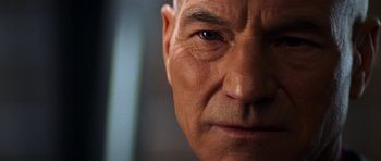 Movie still from “Star Trek: Nemesis” (2002), directed by Stuart Baird – An older man's face is shown in close - up; Extreme Close Up shot, Over the shoulder angle