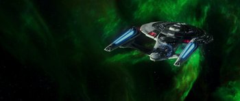 Movie still from “Star Trek: Nemesis” (2002), directed by Stuart Baird – A space ship is flying through the night sky; Extreme Wide shot, Low angle