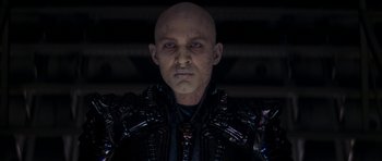 Movie still from “Star Trek: Nemesis” (2002), directed by Stuart Baird – A man with a bald head and blue eyes; Medium shot, Low angle