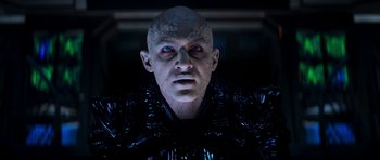 Movie still from “Star Trek: Nemesis” (2002), directed by Stuart Baird – A man's face in a dark room; Close Up shot, Low angle