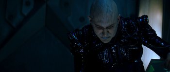 Movie still from “Star Trek: Nemesis” (2002), directed by Stuart Baird – A man with a bald head wearing a black jacket; Close Up shot, High angle