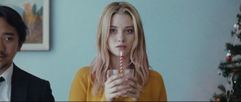 Movie still from “Starfish” (2018), directed by A.T. White – A woman holding a cup with a straw in her hand; Close Up shot, Over the shoulder angle