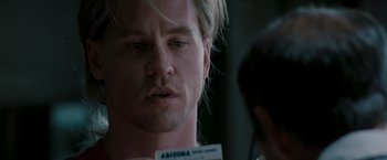Movie still from “Heat” (1995), directed by Michael Mann – A person with a name tag; Close Up shot, Over the shoulder angle