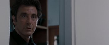 Movie still from “Heat” (1995), directed by Michael Mann – A man's face in front of a mirror; Close Up shot, Over the shoulder angle