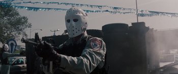 Movie still from “Heat” (1995), directed by Michael Mann – A man wearing a hockey mask while holding a gun in his hand; Close Up shot, Low angle