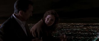 Movie still from “Heat” (1995), directed by Michael Mann – A man and a woman sitting at a dinner table; Medium shot, High angle