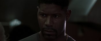 Movie still from “Heat” (1995), directed by Michael Mann – A person wearing a necklace; Close Up shot, Low angle
