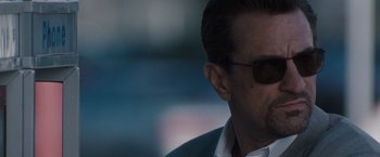 Movie still from “Heat” (1995), directed by Michael Mann – A person wearing sunglasses; Close Up shot, Over the shoulder angle