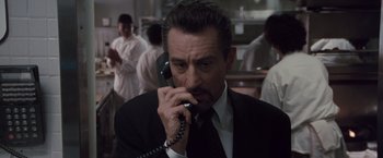 Movie still from “Heat” (1995), directed by Michael Mann – A man talking on the phone; Close Up shot, Low angle