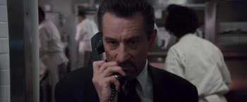 Movie still from “Heat” (1995), directed by Michael Mann – A person talking on a phone; Close Up shot, Low angle