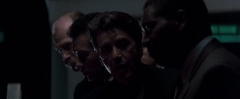 Movie still from “Heat” (1995), directed by Michael Mann – A group of men standing next to each other in the dark; Close Up shot, Low angle