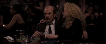 Movie still from “Heat” (1995), directed by Michael Mann – A man and a woman sitting at a table with a drink; Medium shot, Low angle