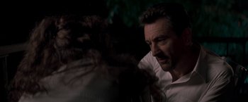 Movie still from “Heat” (1995), directed by Michael Mann – A person sitting down; Close Up shot, Over the shoulder angle