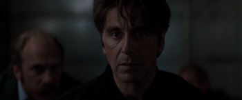 Movie still from “Heat” (1995), directed by Michael Mann – A person wearing a black shirt; Close Up shot, Over the shoulder angle