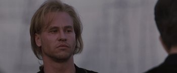 Movie still from “Heat” (1995), directed by Michael Mann – A person with long blonde hair; Close Up shot, Low angle