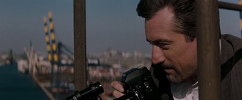 Movie still from “Heat” (1995), directed by Michael Mann – A person holding a camera; Close Up shot, High angle