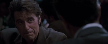 Movie still from “Heat” (1995), directed by Michael Mann – A person sitting in front of a camera; Close Up shot, Over the shoulder angle