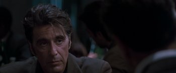 Movie still from “Heat” (1995), directed by Michael Mann – A person sitting down; Close Up shot, Over the shoulder angle