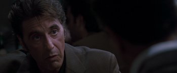 Movie still from “Heat” (1995), directed by Michael Mann – A person wearing a suit and tie; Close Up shot, Over the shoulder angle