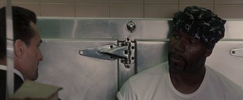 Movie still from “Heat” (1995), directed by Michael Mann – A metal door with a lock on the side of it; Close Up shot, Overhead angle