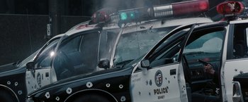 Movie still from “Heat” (1995), directed by Michael Mann – A police car that has bullet holes in the windshield; Wide shot, High angle