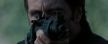 Movie still from “Heat” (1995), directed by Michael Mann – A person holding a gun; Extreme Close Up shot, Low angle