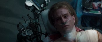 Movie still from “Heat” (1995), directed by Michael Mann – A man in a hospital bed with an oxygen mask on; Close Up shot, Overhead angle
