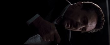 Movie still from “Heat” (1995), directed by Michael Mann – A person wearing a suit and tie; Close Up shot, Low angle