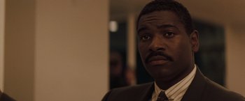 Movie still from “Heat” (1995), directed by Michael Mann – A person wearing a suit and tie; Close Up shot, Low angle