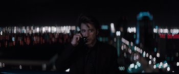 Movie still from “Heat” (1995), directed by Michael Mann – A man in a black suit is talking on a cell phone; Close Up shot, Low angle