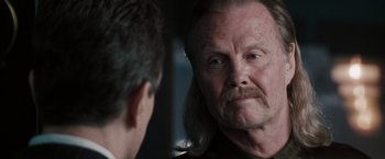 Movie still from “Heat” (1995), directed by Michael Mann – A man with long hair and a mustache looking at himself in the mirror; Close Up shot, Over the shoulder angle