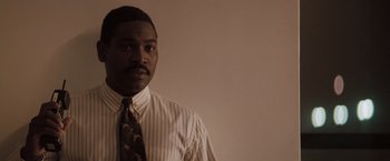 Movie still from “Heat” (1995), directed by Michael Mann – A man wearing a striped shirt and a tie; Close Up shot, Low angle