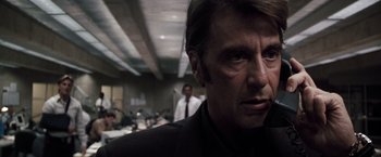 Movie still from “Heat” (1995), directed by Michael Mann – A person wearing a suit and tie; Close Up shot, Low angle