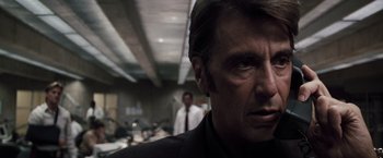 Movie still from “Heat” (1995), directed by Michael Mann – A person wearing a suit and tie; Close Up shot, Low angle