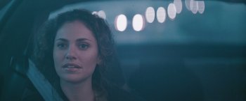 Movie still from “Heat” (1995), directed by Michael Mann – A woman's face in the dark; Close Up shot, Over the shoulder angle