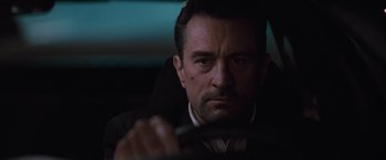 Movie still from “Heat” (1995), directed by Michael Mann – A person driving a car; Close Up shot, Low angle