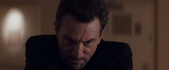Movie still from “Heat” (1995), directed by Michael Mann – A person with a black shirt; Close Up shot, Low angle