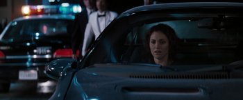 Movie still from “Heat” (1995), directed by Michael Mann – A woman sitting in the back seat of a car; Close Up shot, Over the shoulder angle
