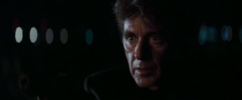 Movie still from “Heat” (1995), directed by Michael Mann – A man's face in the dark; Close Up shot, Over the shoulder angle