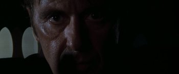 Movie still from “Heat” (1995), directed by Michael Mann – A man's face in the dark; Extreme Close Up shot, Low angle