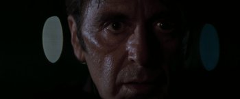 Movie still from “Heat” (1995), directed by Michael Mann – A man's face in the dark; Close Up shot, Low angle