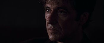 Movie still from “Heat” (1995), directed by Michael Mann – A man's face in the dark; Close Up shot, Over the shoulder angle