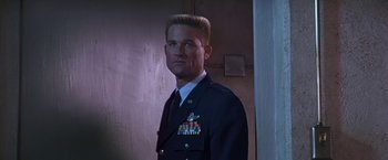 Movie still from “Stargate” (1994), directed by Roland Emmerich – A man in a military uniform standing in a room; Close Up shot, Low angle